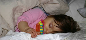 Ainsley biting teething ring while sleeping